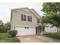 This two-story home includes an attached two-car garage, a covered porch, and manicured landscaping at 10510 Mcclain Dr, Brownsburg, IN 46112