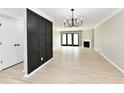 Spacious living room with fireplace, modern light fixture, and vinyl floors at 1053 Millwood Ct # 3, Indianapolis, IN 46260