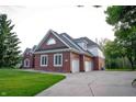 Expansive two-story home with brick and vinyl siding, attached garages, and lush green landscaping at 1188 Old Eagle Way, Greenwood, IN 46143