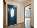Inviting foyer with a decorative front door, wood-look flooring, and trim accents at 12157 Longstraw Dr, Indianapolis, IN 46236