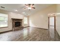 Bright living room boasts wood-look flooring, a brick fireplace, and a comfortable open layout at 12157 Longstraw Dr, Indianapolis, IN 46236