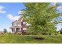 Well-maintained two-story home showcasing a landscaped yard and inviting curb appeal at 1313 Brentford Ln, Greenwood, IN 46143