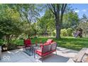 Relaxing backyard patio with comfortable seating, lush landscaping, and a playset at 1408 126Th St, Carmel, IN 46033
