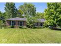 Charming single-story brick home with a well-manicured lawn, mature trees, and traditional shutters at 1408 126Th St, Carmel, IN 46033