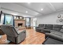 Inviting living room features a brick fireplace, comfortable seating, and hardwood floors at 1408 126Th St, Carmel, IN 46033