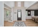 Bright foyer features hardwood floors, a statement rug, and seamless transition to living areas at 14662 Woodstone Cir, Fishers, IN 46037