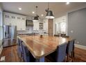 Spacious kitchen with a large wooden island, stainless steel appliances, and open layout at 1512 Bellefontaine St, Indianapolis, IN 46202