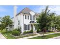 Beautiful two-story white brick house featuring classic black shutters and a well-manicured lawn with mature trees at 1655 Avondale Dr, Westfield, IN 46074