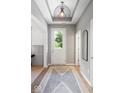 Bright foyer featuring decorative lighting, wood flooring, and neutral paint at 1655 Avondale Dr, Westfield, IN 46074