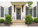 Inviting front entry with gray door, decorative wreath, and dual chairs at 1655 Avondale Dr, Westfield, IN 46074