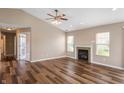 Inviting living room featuring hardwood floors, fireplace, and multiple windows for bright, natural light at 16956 Fulton Pl, Westfield, IN 46074