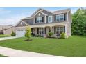 Charming two-story home with a lush green lawn, covered front porch, and an attached two-car garage at 1715 Foudray S Cir, Avon, IN 46123