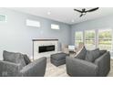 Cozy living room features a modern fireplace, gray sofas, and bright natural light at 1723 Fletcher Ave, Indianapolis, IN 46203