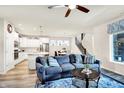 Open-concept living room featuring stylish decor, a comfortable sofa, and seamless flow to the modern kitchen at 17319 Henslow Dr, Westfield, IN 46074