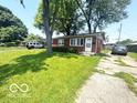 Charming brick ranch-style home with a green lawn and a driveway with parking at 1820 Martin St, Indianapolis, IN 46237