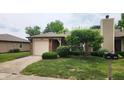 Charming single Gathering home with an attached garage and a beautifully landscaped front yard at 1836 Queensbridge Cir, Indianapolis, IN 46219