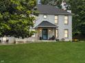 Inviting two-story brick home with a covered front porch and well-manicured lawn at 2015 Deer Lake Dr, Martinsville, IN 46151