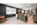 Open-concept living room featuring modern furnishings, plenty of natural light, and hardwood floors at 22 N Bolton Ave, Indianapolis, IN 46219