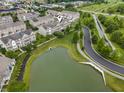 Aerial view showcasing a neighborhood with pond, walking path, and proximity to green spaces at 258 Coatsville Dr, Westfield, IN 46074