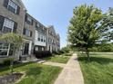 Attractive brick townhouses with sidewalks, landscaped yards, and mature trees in a well-maintained community at 258 Coatsville Dr, Westfield, IN 46074