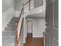 Inviting home foyer with staircase, wood floors, and neutral color palette at 258 Coatsville Dr, Westfield, IN 46074
