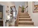 View of the entryway with staircase with wood accents and neutral decor at 2925 Horse Hill East Dr, Indianapolis, IN 46214