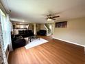 Open-concept living room with hardwood floors, sofas, and staircase to the second floor at 3065 Hemlock Way, Indianapolis, IN 46203