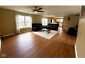 Spacious living room with hardwood floors and multiple sofas, flowing into the kitchen at 3065 Hemlock Way, Indianapolis, IN 46203