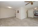 Open living room with carpet, ceiling fan, and access to other rooms at 311 Thornberry Dr, Carmel, IN 46032