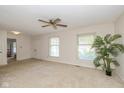 Bright living room featuring neutral walls, carpet, a ceiling fan, and natural light at 311 Thornberry Dr, Carmel, IN 46032
