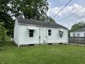 Exterior shot of home's rear, highlighting the backyard and landscaping at 330 S Butler Ave, Indianapolis, IN 46219