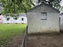 A view of a detached garage with a small yard at 330 S Butler Ave, Indianapolis, IN 46219