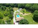 Expansive property with a pool, pond, large lawn and mature trees offering privacy and space at 3325 Kivett Ln, Martinsville, IN 46151