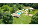 Expansive property with a pool, pond, large lawn and mature trees offering privacy and space at 3325 Kivett Ln, Martinsville, IN 46151
