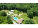 Expansive property with a pool, pond, large lawn and mature trees offering privacy and space at 3325 Kivett Ln, Martinsville, IN 46151