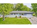 Charming single-story home with a well-maintained lawn, driveway, and attached garage at 3414 Ferncliff Ave, Indianapolis, IN 46227