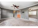 Spacious living room with neutral carpet, ceiling fan, and access to a hallway and another room at 3414 Ferncliff Ave, Indianapolis, IN 46227