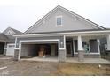 New construction features a two-car garage and stone accents on the gray exterior at 3599 Hauser Ct, Bargersville, IN 46106