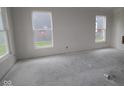 Spacious living room area with two windows showing the yard outside at 3599 Hauser Ct, Bargersville, IN 46106