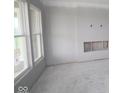 Bright living room featuring large windows and an empty fireplace, awaiting your personal design at 3611 Hauser Ct, Bargersville, IN 46106