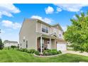 Exterior view of a two-story home, showcasing its vinyl siding, covered porch, and landscaped front yard at 3811 Tartan Trl, Whitestown, IN 46075