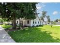 Well-kept home exterior with a green lawn and tree, offering a pleasant curb appeal at 402 E 4Th St, Sheridan, IN 46069