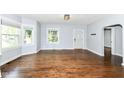 Spacious living room showcasing hardwood floors, natural light, and a convenient entry door at 402 E 4Th St, Sheridan, IN 46069