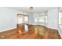 Bright living room featuring hardwood floors, large windows, and an open archway at 402 E 4Th St, Sheridan, IN 46069
