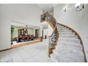 Elegant formal dining room with a large table, chairs, and staircase at 4181 Whitetail Woods Dr, Bargersville, IN 46106