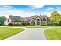 Beautiful home exterior with manicured lawn, mature trees, and a grand entrance at 4181 Whitetail Woods Dr, Bargersville, IN 46106