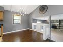 Open dining room with modern lighting, hardwood floors, and a view of the fireplace at 4718 Dancer Dr, Indianapolis, IN 46237