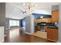 Open-concept living space with kitchen, dining area, and hardwood floors at 4718 Dancer Dr, Indianapolis, IN 46237