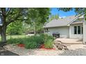 Landscaped backyard featuring a stone garden, lush foliage, and a well-maintained lawn at 5431 Nathan Pl, Indianapolis, IN 46237
