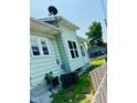 Side of house with windows, siding, and a small yard area at 547 N Livingston Ave, Indianapolis, IN 46222
